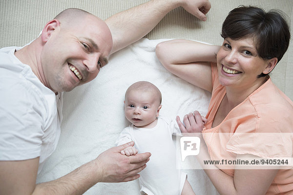 Portrait of parents with baby boy  smiling