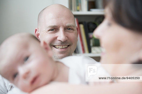 Parents with baby boy  smiling  close up