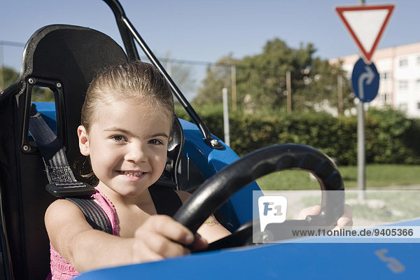 Smiling girl in vehicle on driver training area