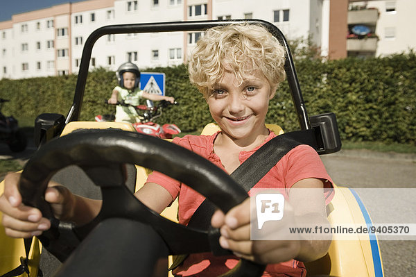 Smiling boy in vehicle on driver training area