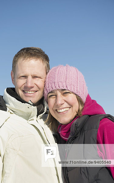 Portrait of couple in winter  smiling