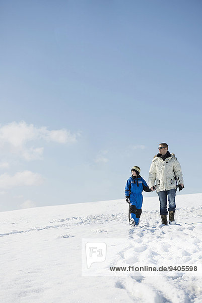 Father and son walking in winter