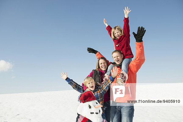 Family with snowman  smiling