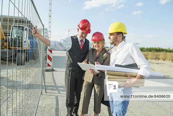 Architect and customers inspecting site