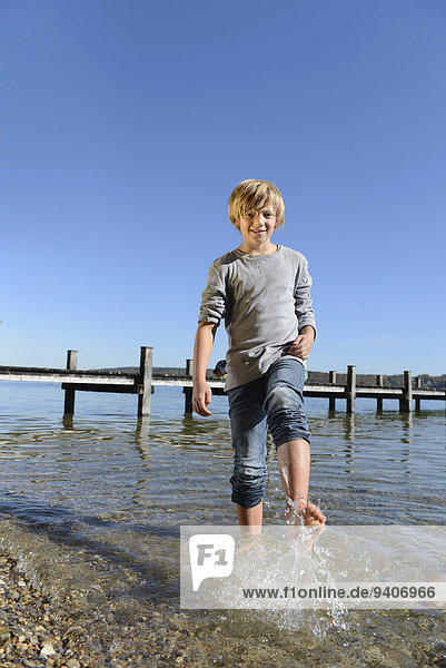 Boy splashing water with his feet  smiling
