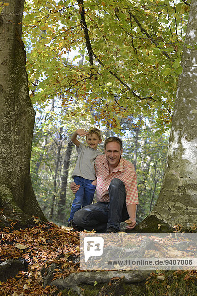Father and son in forest  smiling