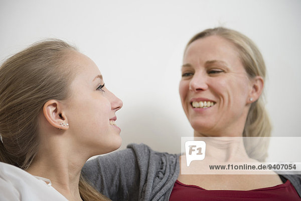 Mother and daughter talking  smiling