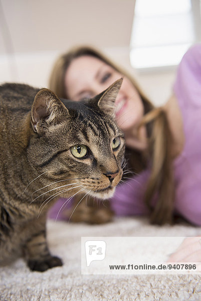 Cat and mature woman at home