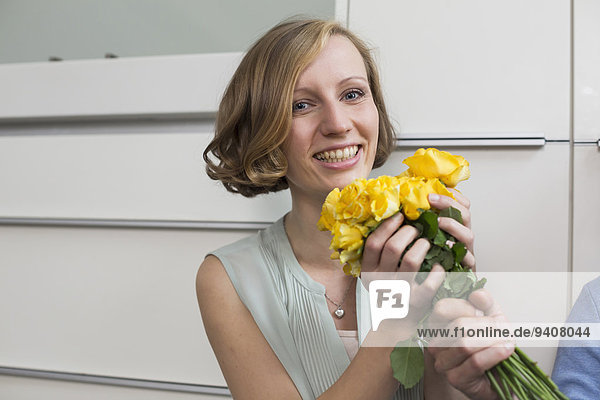 Happy woman receiving bunch of roses