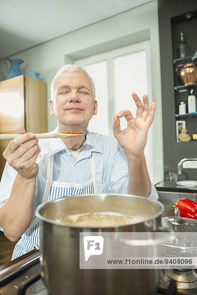 Mature man preparing food in kitchen
