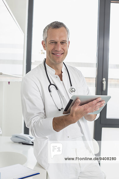 Doctor holding digital tablet  portrait
