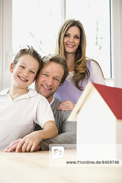 Family with architectural model at table