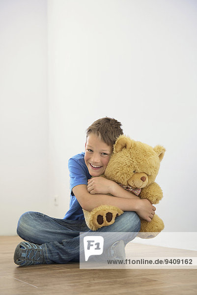 Fröhlichkeit Junge - Person halten Spielzeug Teddy Teddybär jung Eigentumswohnung neues Zuhause