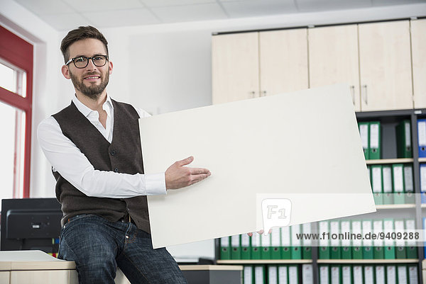 Young man office holding poster sign advert
