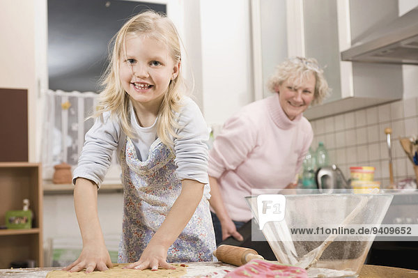 Grandother and granddaughter preparing cookies