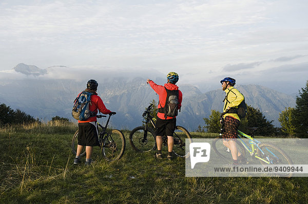 three mountain bikers looking at view  Kolovrat  Istria  Slovenia