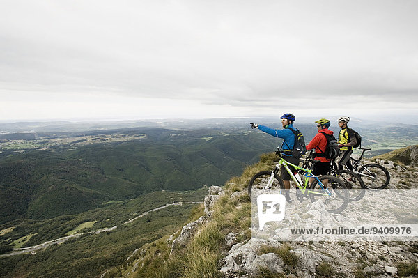 three mountain bikers looking at view  Vipava valley  Istria  Nanos  Slovenia