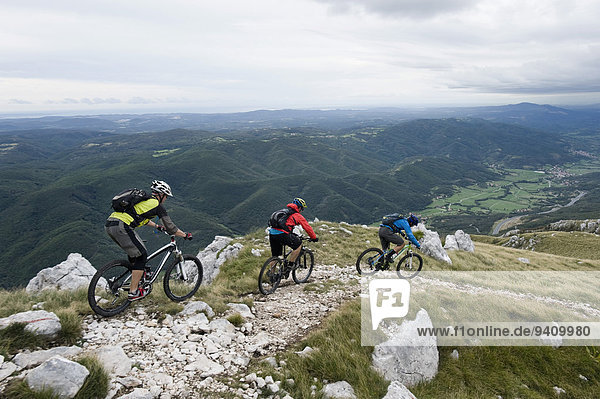 three mountain bikers looking at view  Vipava valley  Istria  Nanos  Slovenia