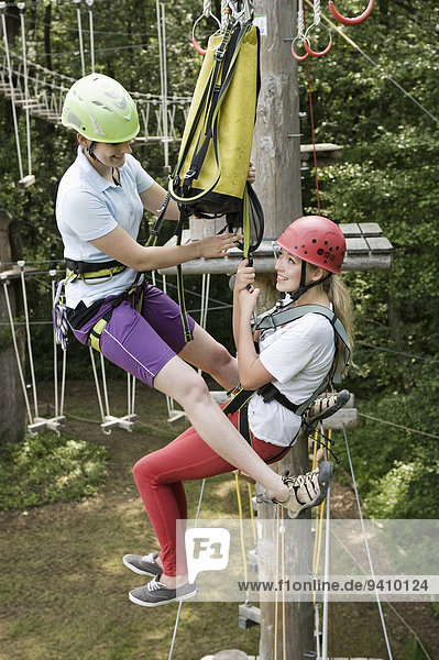 female teenager and a young female instructor in a climbing crag