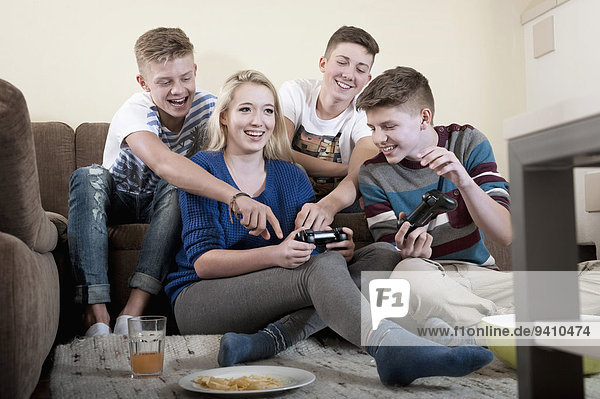 Friends playing video game in living room