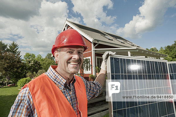 Portrait workman helmet smiling solar panel