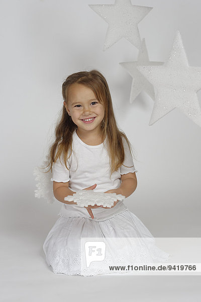 Child  girl wearing an angel costume with stars  Christmas  festive season