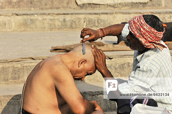 Ritual hair cutting on the Ganges  Varanasi  Benares  Uttar Pradesh  India