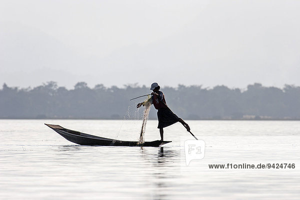 Fisherman  leg rower  on a boat on Inle Lake  Shan State  Myanmar