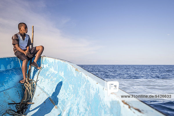 Boy on a fishing boat looking out to the sea  Yasawa Islands  Fischi