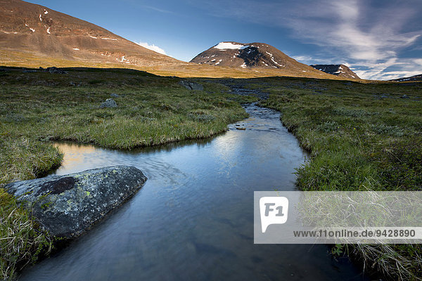 Midnight sun in the Fjaell Mountains with a small stream along the Kungsleden  The King's Trail  Lapland  Sweden  Europe