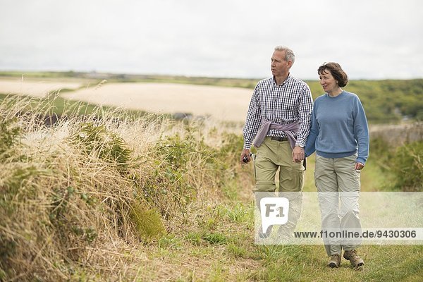 Couple walking  Coast Path near Marloes  Pembrokeshire Coast National Park  Wales  UK
