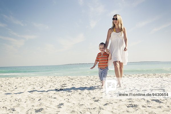 Mid adult mother and young son strolling on beach  Cape Town  Western Cape  South Africa
