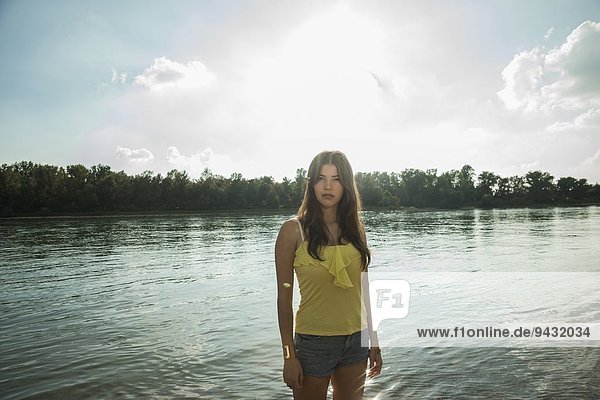 Young woman by lake