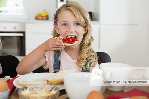Girl eating at kitchen table