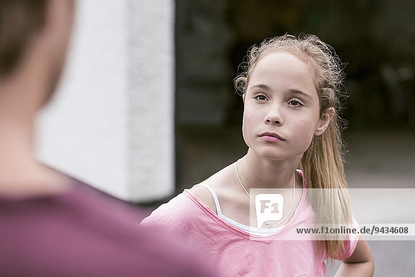 Angry girl looking at father outdoors