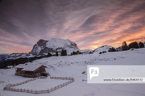 Sunrise over Mt Plattkofel and a mountain hut in winter  Saltria  South Tyrol  Italy  Europe