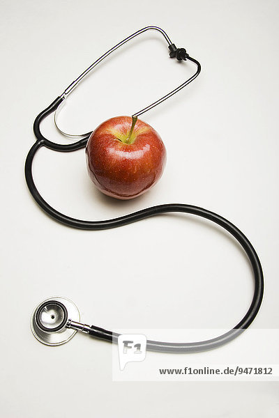 Stethoscope and red apple concept: An apple a day keeps the doctor away