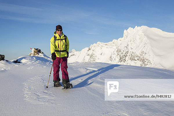 Snowshoe hikers on snowshoe tour on Tverrfjellet  Kvaloya  Mikkelvik  Troms  Norway  Europe