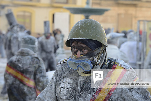 Man wearing goggles  Els Enfarinats flour fight  rebels  armed with flour  eggs and firecrackers  take over the regiment of the city for one day  Plaza de la Iglesia  Ibi  Province of Alicante  Costa Blanca  Spain  Europe