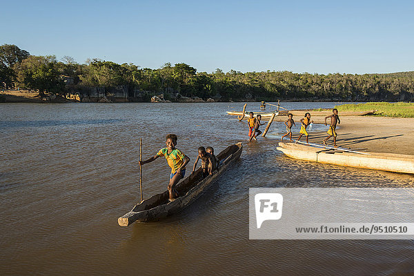 Children with pirogue or dugout  on the river Manambolo  Bekopaka Manambolo  Madagascar  Africa