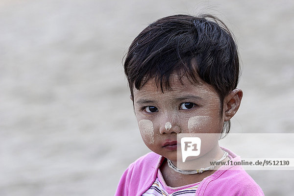 Girl with Thanaka paste on her face  in Bagan  Myanmar  Asia
