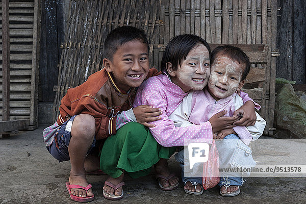 Local children  with Thanaka paste in their faces  Nyaaungshwe  Shan State  Myanmar  Asia