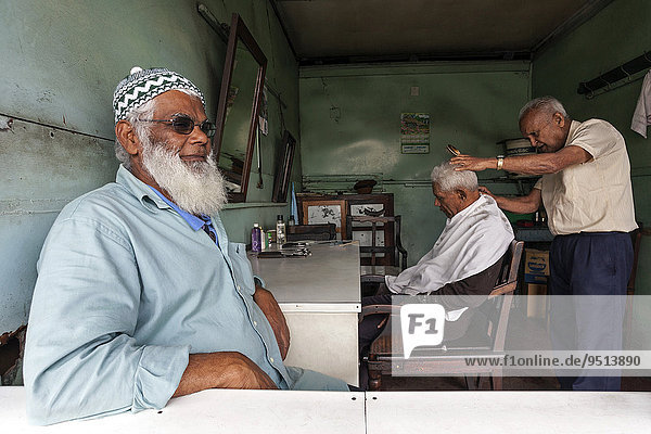 Local men at the hairdresser's Mahebourg Mauritius Africa