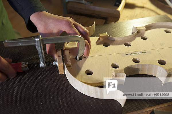 Violin making  attaching the wooden tun ring