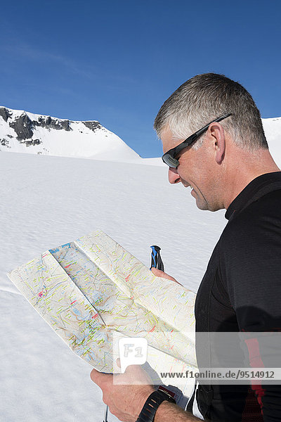 Mountaineer with orientation map  Oppland  Norway  Europe