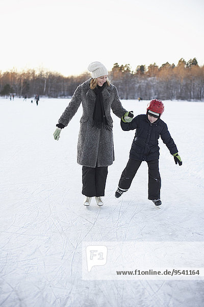 Mother with son ice skating