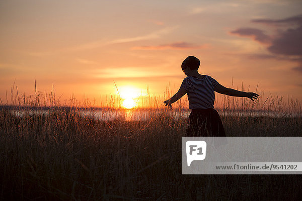 Silhouette of woman at sunset