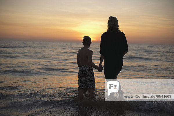 Mother with son looking at sunset