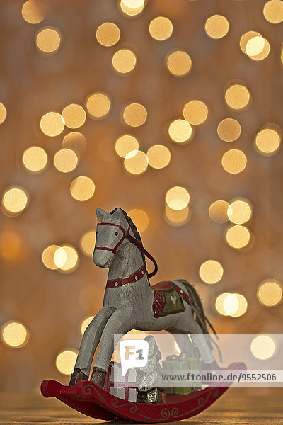 Christmas rocking horse in front of points of light