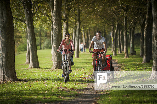 Family riding bicycle in park